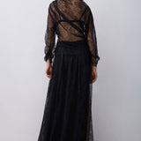 Woman wearing a black lace outfit on a white background