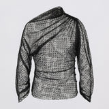 Black and white patterned blouse on a light gray background