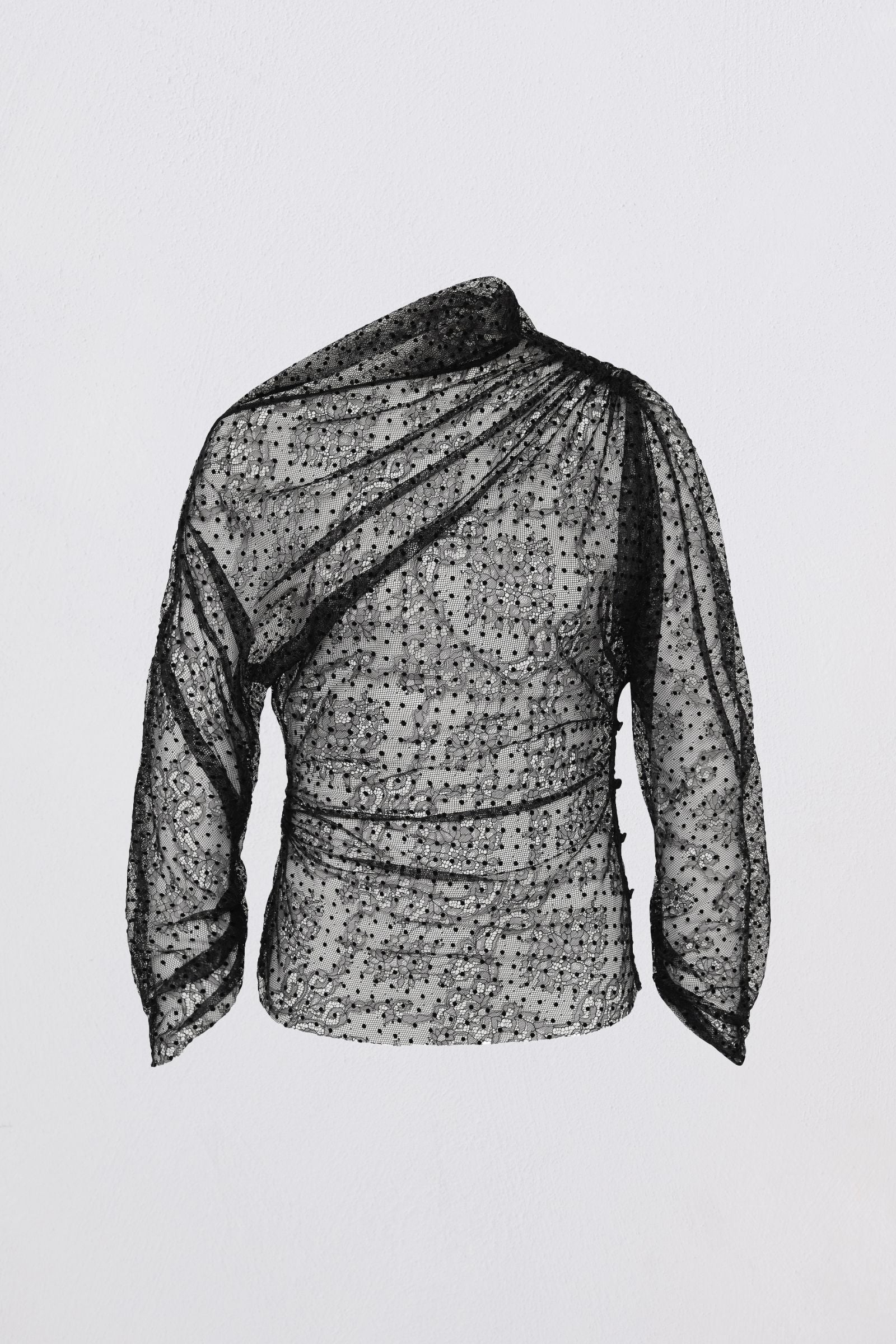 Black and white patterned blouse on a light gray background