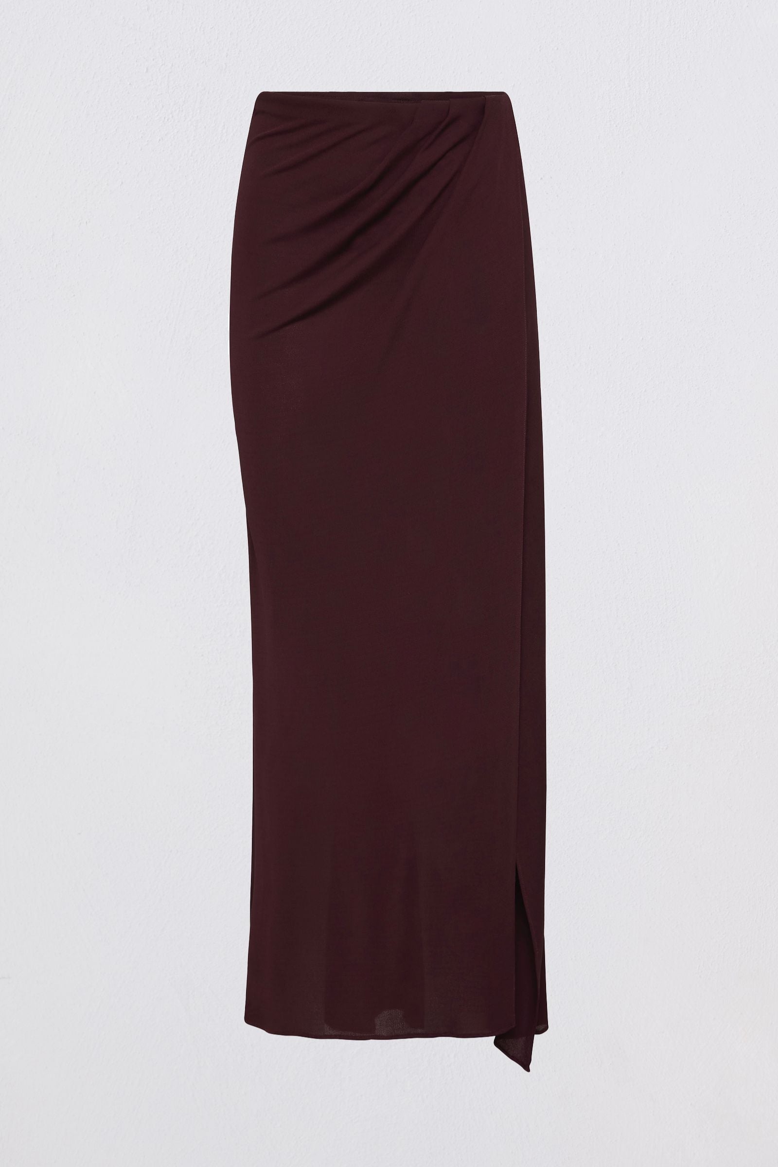 A dark burgundy wrap midi skirt with a draped waist and side slit, displayed on a clean white background.