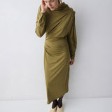 Woman wearing a green dress against a white background