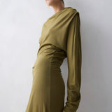 Woman wearing a green dress against a white background