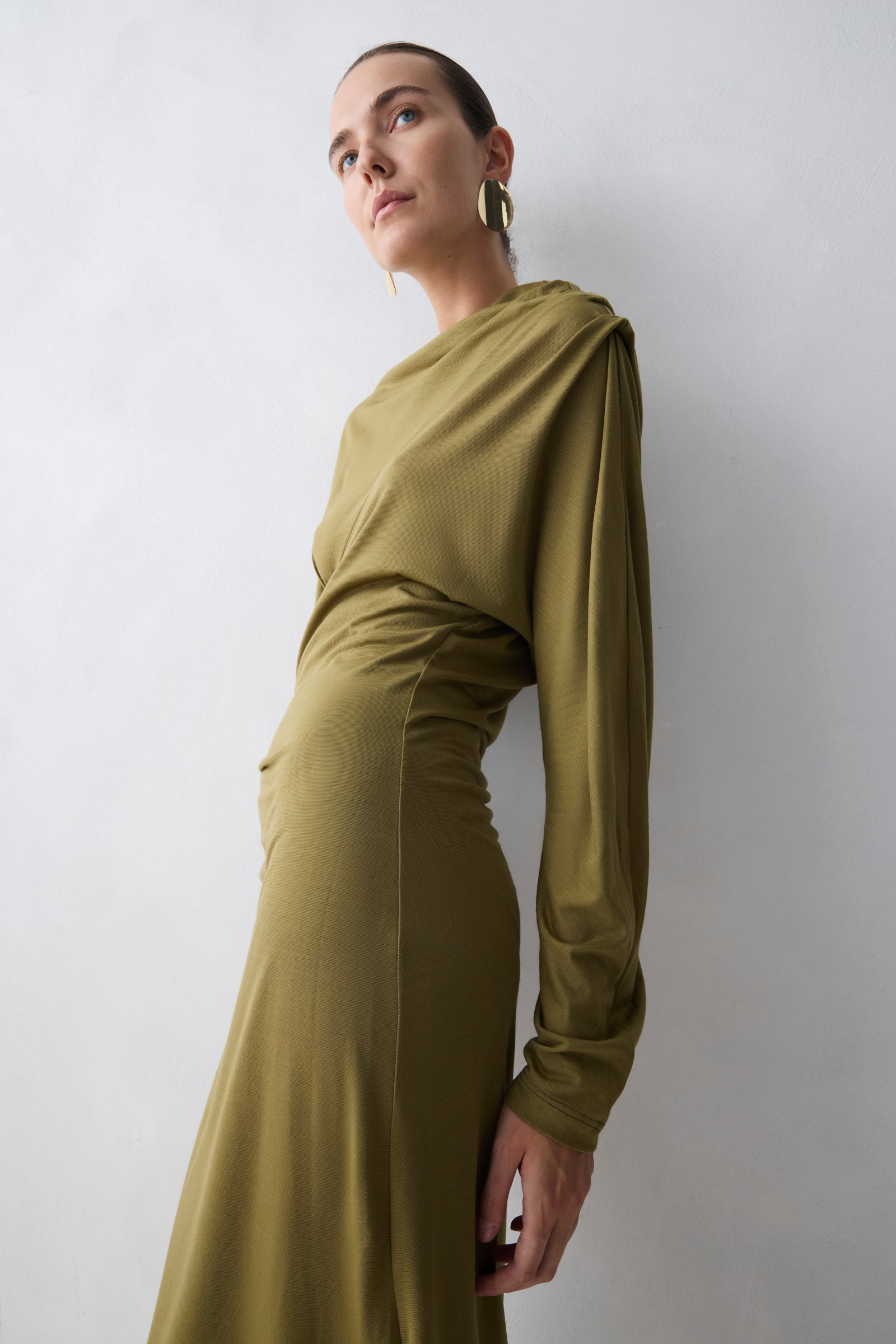 Woman wearing a green dress against a white background