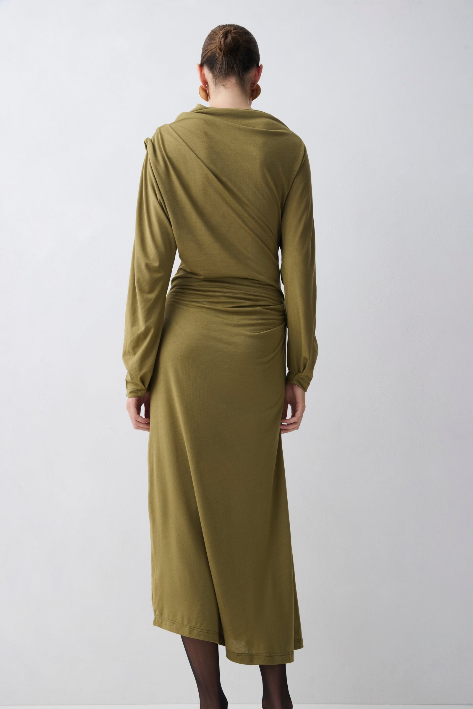 Woman wearing a green dress with a white background