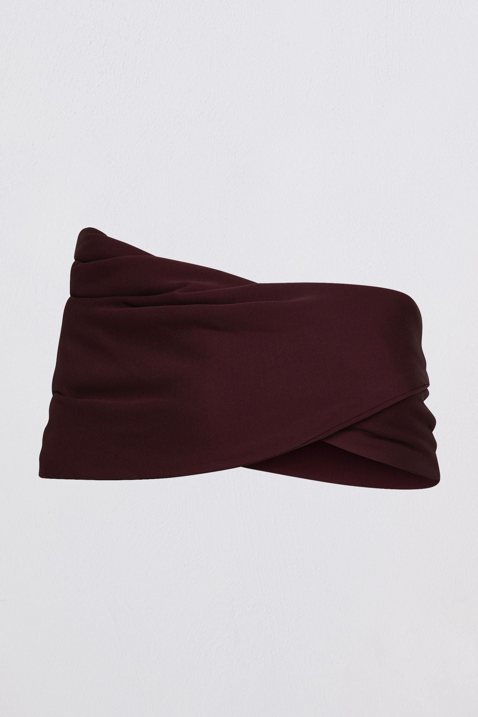 A dark burgundy twisted bustier top made of smooth fabric, displayed flat against a light gray background.