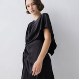 Woman wearing a black dress against a white background