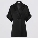 Black coat with short sleeves on a light gray background