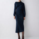 Person wearing a navy blue outfit on a white background