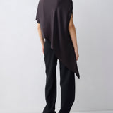 Person wearing a black sleeveless top and pants on a white background