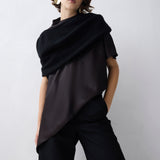 Person wearing a black outfit against a white background