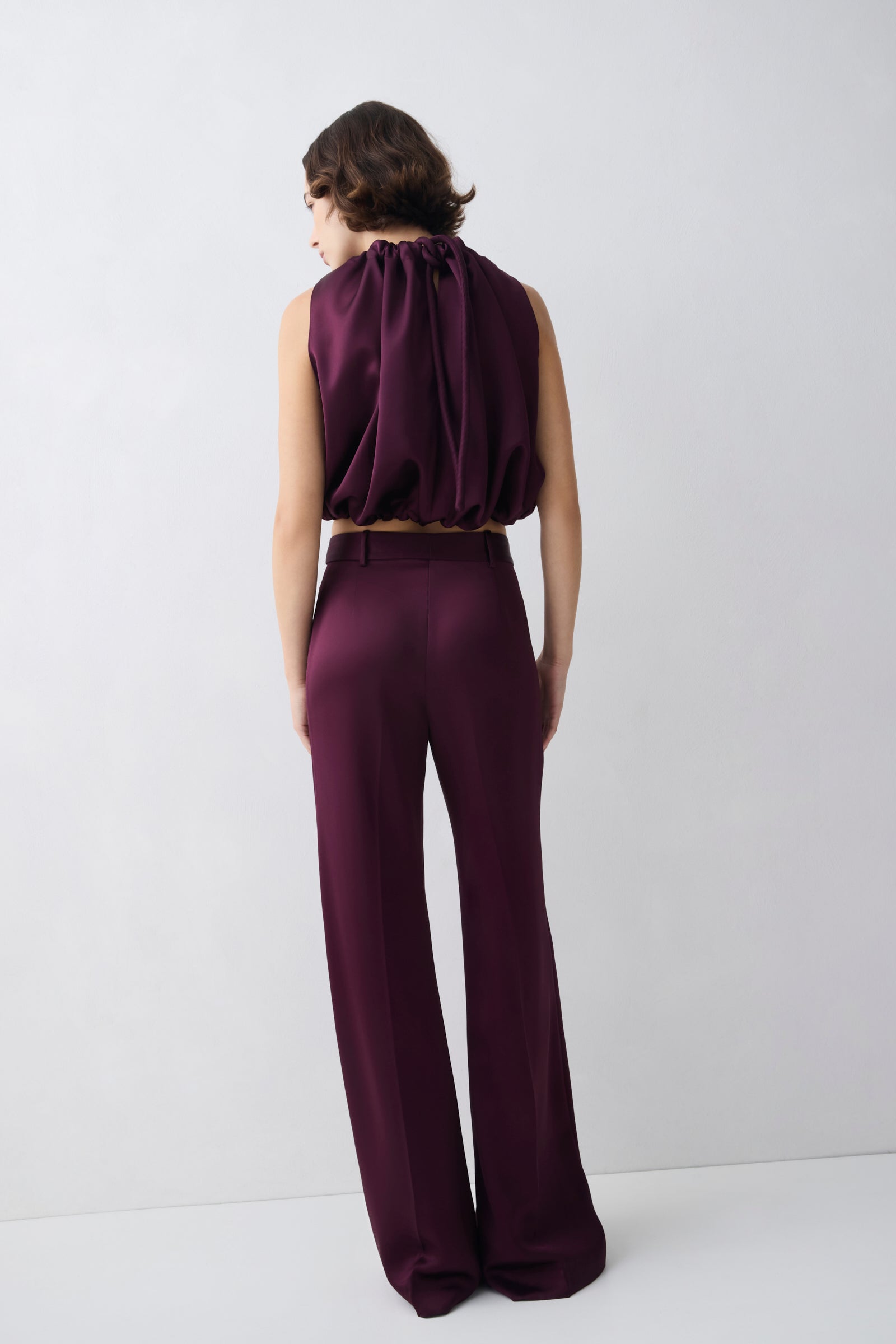 Person wearing a purple outfit on a white background