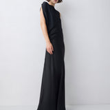 Woman wearing a black sleeveless dress against a white background