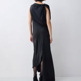 Woman wearing a black sleeveless dress with a slit on a white background