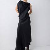 Woman wearing a black draped dress on a white background