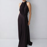 Woman wearing a black halter neck gown against a white background