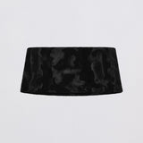 Black velvet headband on a light gray background