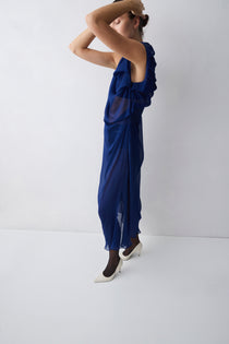 Woman wearing a blue dress against a white background