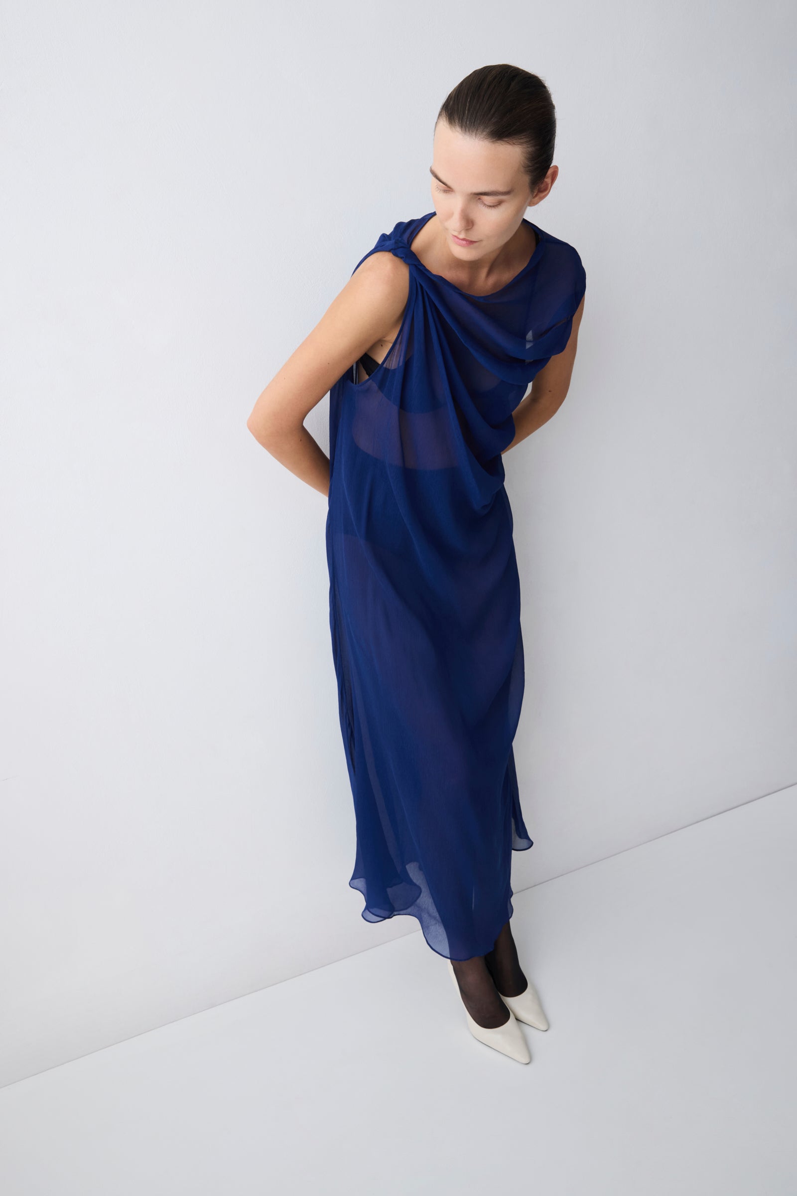 Woman wearing a blue dress against a white background