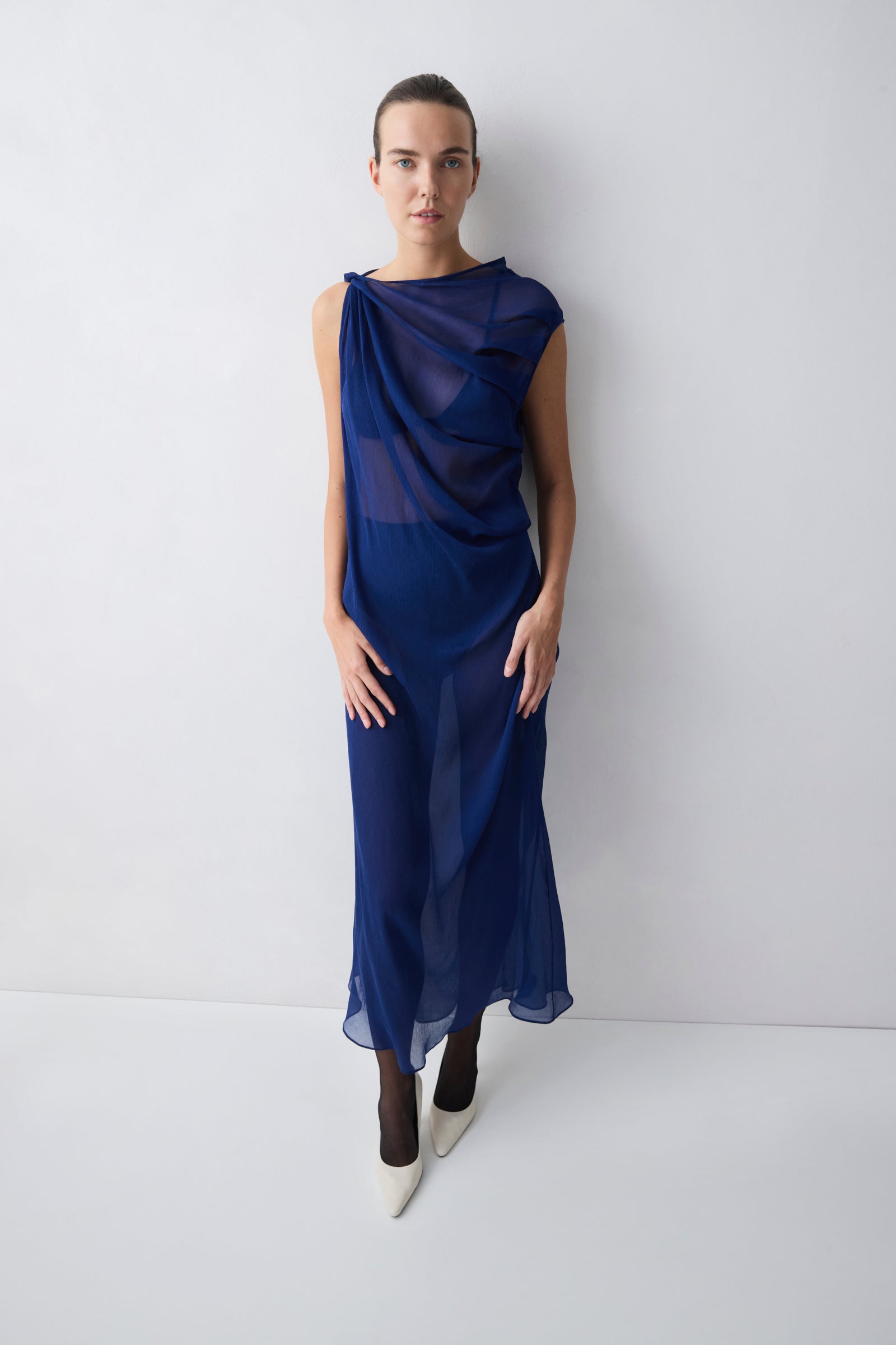 Woman wearing a blue dress against a white background