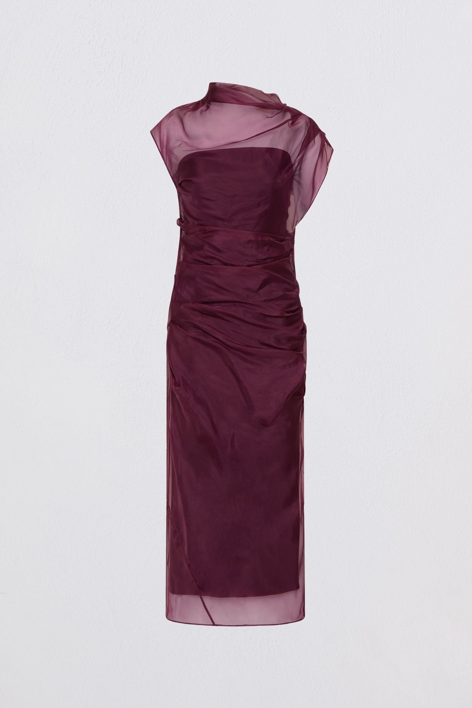 Woman wearing a purple dress with a plain white background