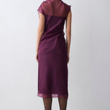 Woman wearing a purple dress on a white background