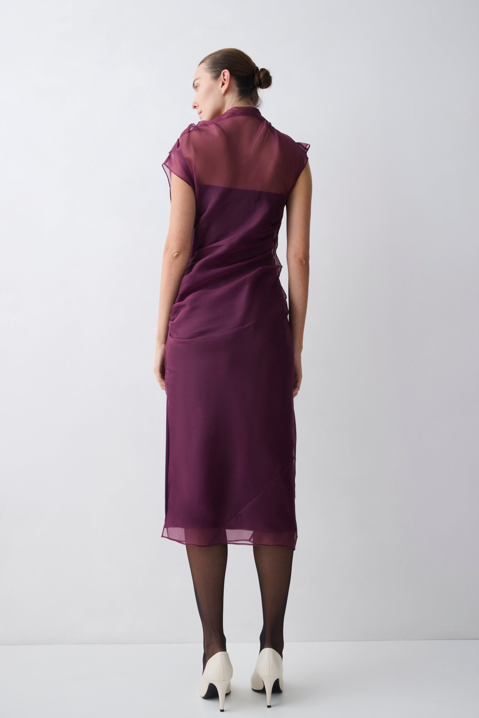 Woman wearing a purple dress on a white background