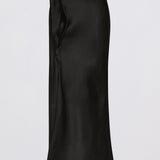 A black satin midi skirt with a wrap-style waist and side slit, shown against a plain light gray background.