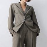 Woman wearing a gray suit with a white background