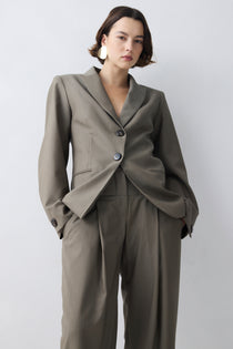 Woman wearing a gray suit with a white background