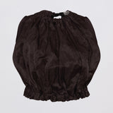A dark brown crinkled fabric crop top with a gathered, balloon-like silhouette, featuring a drawstring waist and ruffled hem, shown against a plain light gray background.