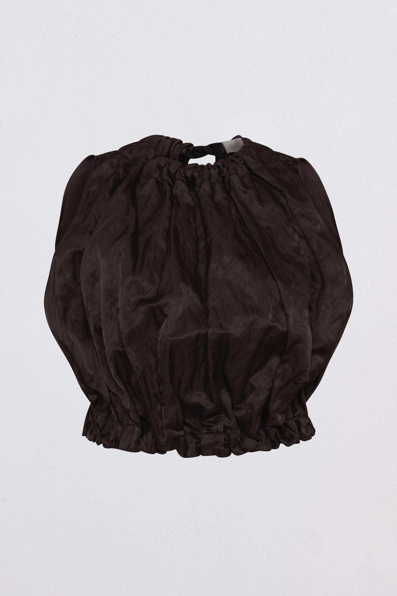 A dark brown crinkled fabric crop top with a gathered, balloon-like silhouette, featuring a drawstring waist and ruffled hem, shown against a plain light gray background.