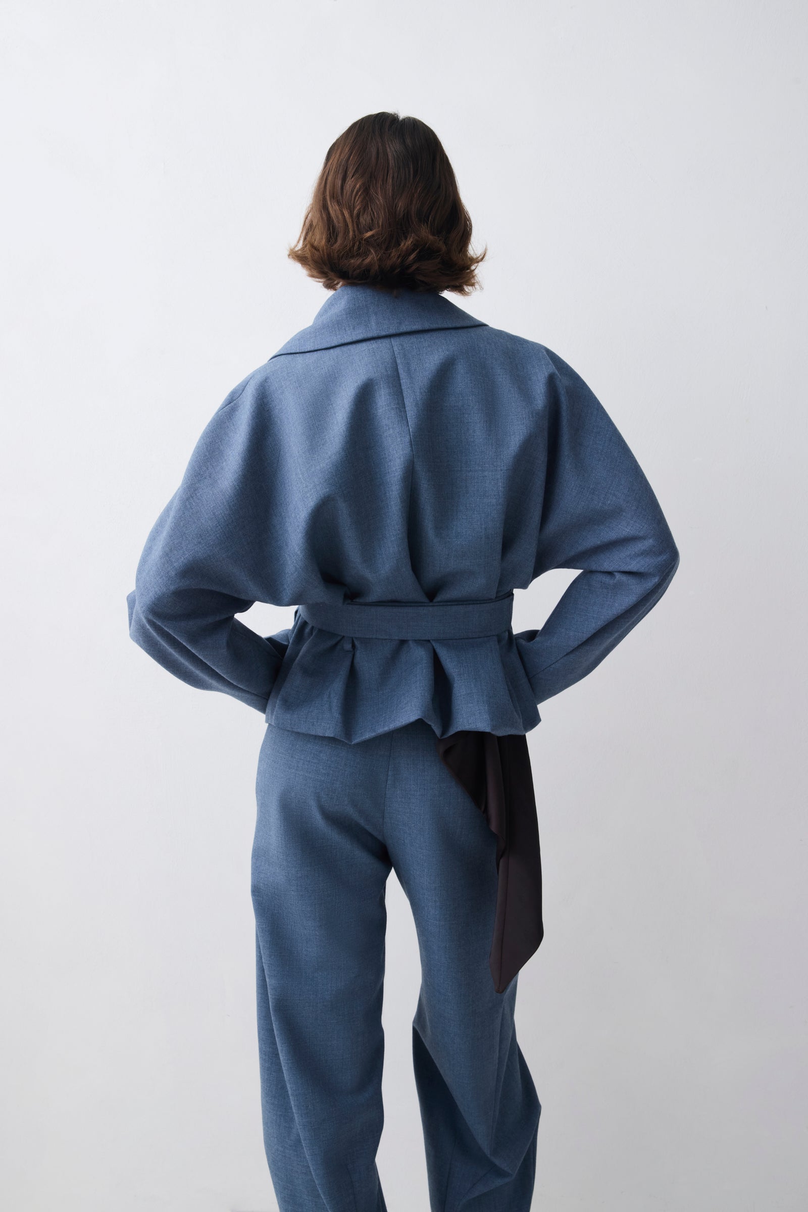 Person wearing a blue outfit with a white background
