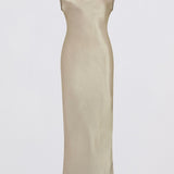 A floor-length champagne satin gown with a draped cowl neckline and cap sleeves, shown against a plain light gray background.